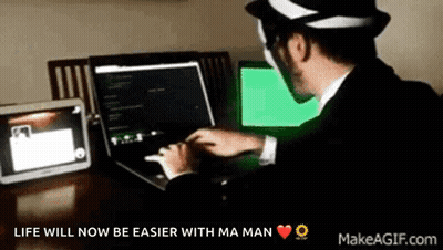 A Man In A Suit Is Typing On A Laptop With The Words " Life Will Now Be Easier With Ma Man " Above Him GIF
