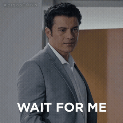 A Man In A Suit Is Waiting For Someone To Wait For Him GIF