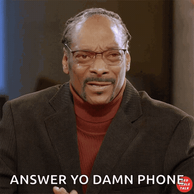 A Man In A Suit Making A Phone Call With His Hand And The Words Answer Yo Damn Phone Below Him GIF