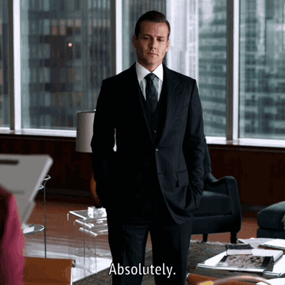 A Man In A Suit Says Absolutely In Front Of A Window GIF