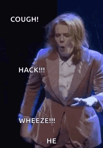 A Man In A Suit Says Cough Hack Wheeze And He On The Screen GIF