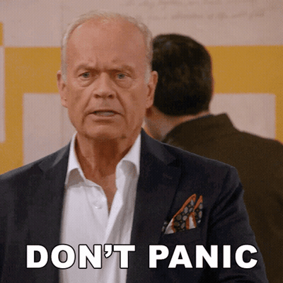 A Man In A Suit Says " Don 'T Panic " GIF