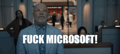 A Man In A Suit Says Fuck Microsoft In Front Of A Crowd GIF