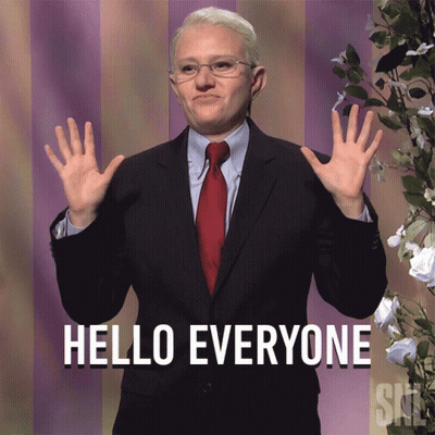 A Man In A Suit Says Hello Everyone With His Hands Up GIF