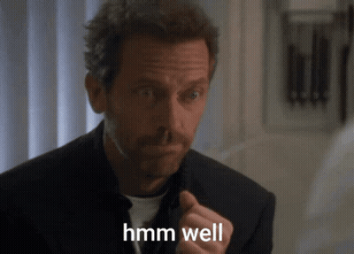 A Man In A Suit Says Hmm Well GIF