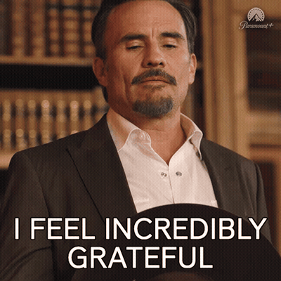 A Man In A Suit Says " I Feel Incredibly Grateful " While Holding A Hat GIF