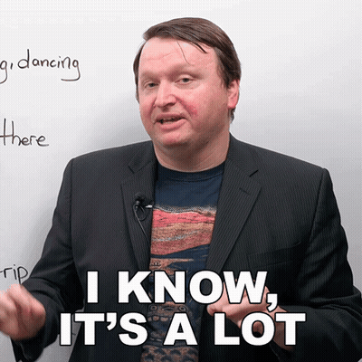 A Man In A Suit Says " I Know It 'S A Lot " In Front Of A White Board GIF