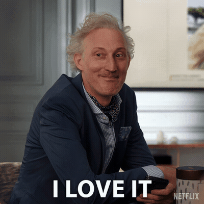 A Man In A Suit Says I Love It While Holding A Cellphone GIF