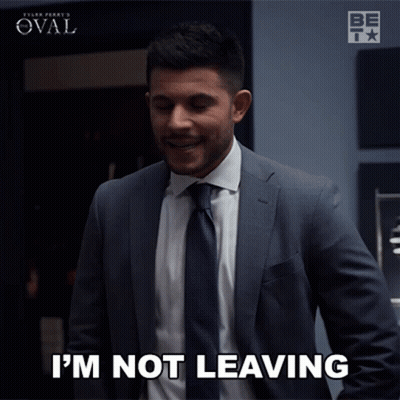A Man In A Suit Says " I 'M Not Leaving " GIF
