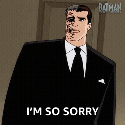 A Man In A Suit Says I 'M So Sorry In Front Of A Batman Logo GIF