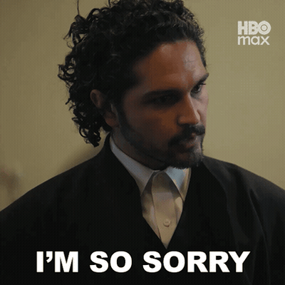 A Man In A Suit Says I 'M So Sorry In Front Of A Hbo Max Logo GIF