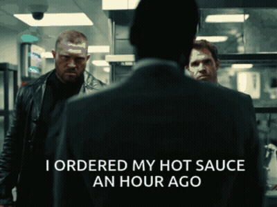 A Man In A Suit Says I Ordered My Hot Sauce An Hour Ago In A Dark Room GIF