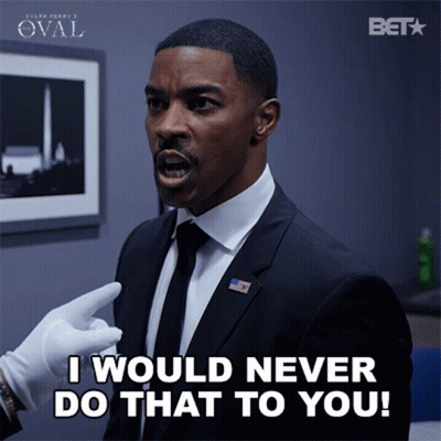 A Man In A Suit Says " I Would Never Do That To You " While Wearing White Gloves GIF