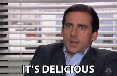 A Man In A Suit Says It 'S Delicious While Sitting In Front Of A Window GIF