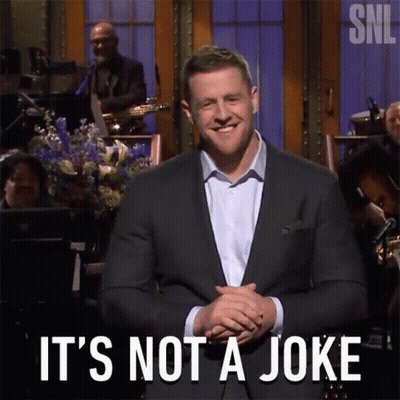 A Man In A Suit Says " It 'S Not A Joke " In Front Of An Orchestra GIF