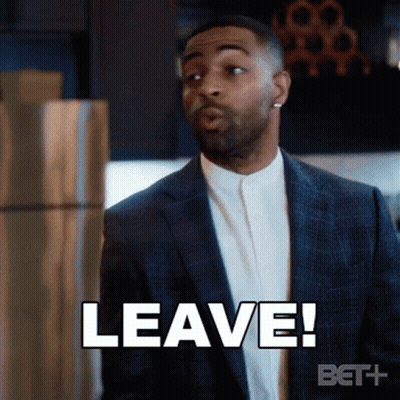 A Man In A Suit Says " Leave " While Standing In Front Of A Refrigerator GIF