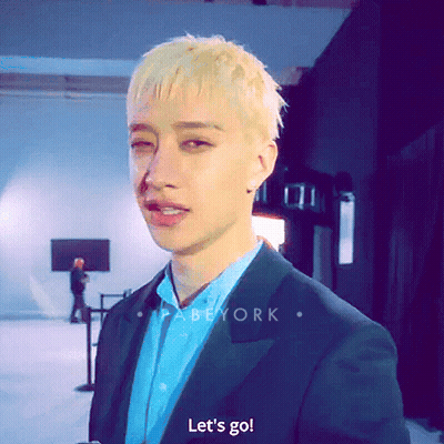 A Man In A Suit Says Let 'S Go In Front Of A Screen GIF