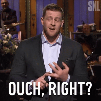 A Man In A Suit Says Ouch Right In Front Of A Band GIF