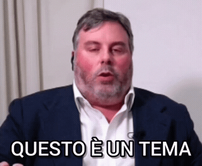 A Man In A Suit Says Questo E Un Tema In A Foreign Language GIF