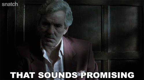 A Man In A Suit Says That Sounds Promising On A Screen GIF