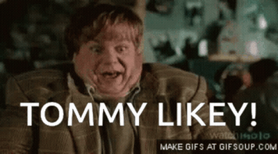 A Man In A Suit Says " Tommy Likey " In Front Of His Face GIF