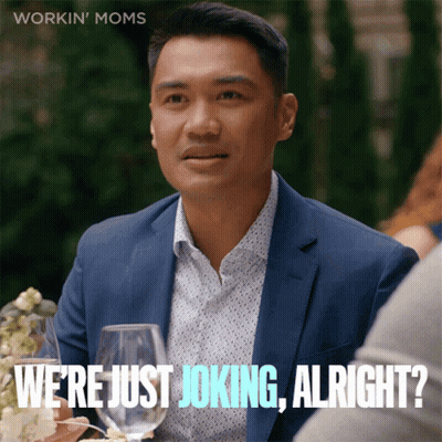 A Man In A Suit Says " We 'Re Just Joking Alright " While Sitting At A Table With Wine Glasses GIF