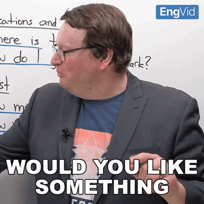 A Man In A Suit Says " Would You Like Something " In Front Of A Whiteboard GIF