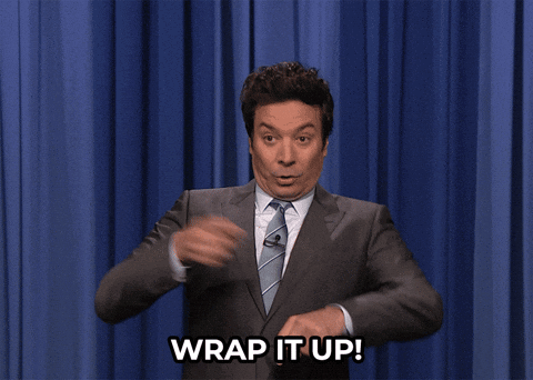 A Man In A Suit Says Wrap It Up In Front Of A Blue Curtain GIF