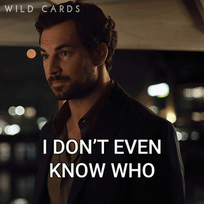 A Man In A Suit Says " You Are Anymore " In Front Of A Sign That Says Wild Cards GIF