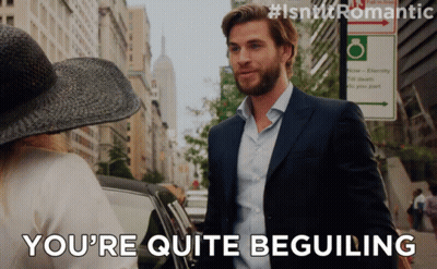 A Man In A Suit Says You 'Re Quite Beguiling To A Woman GIF
