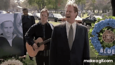 A Man In A Suit Sings While Another Man Plays Guitar GIF