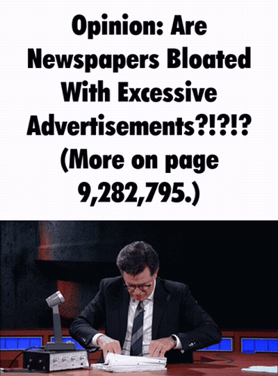 A Man In A Suit Sits At A Desk With A Sign That Says Opinion Are Newspapers Bloated With Excessive Advertisement GIF