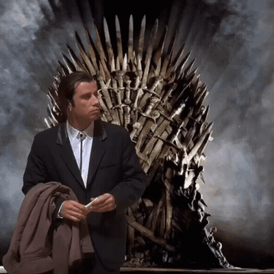 A Man In A Suit Sits In Front Of A Throne GIF