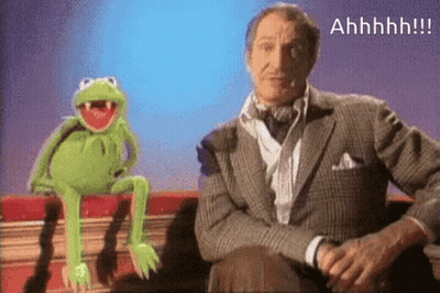 A Man In A Suit Sits Next To A Kermit The Frog GIF