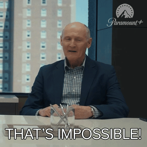 A Man In A Suit Sitting At A Table With The Words That 'S Impossible GIF