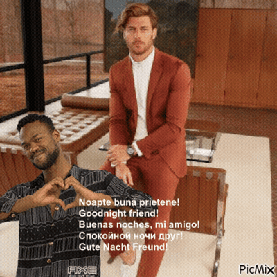 A Man In A Suit Sitting Next To Another Man Who Is Making A Heart With His Hands GIF