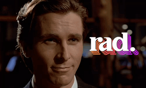 A Man In A Suit Smiles In Front Of The Rad Logo GIF