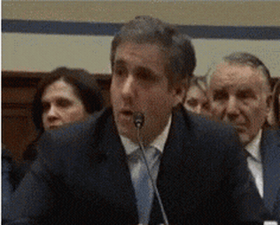 A Man In A Suit Speaking Into A Microphone GIF