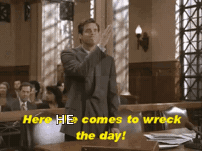 A Man In A Suit Stands In A Courtroom With The Words Here He Comes To Wreck The Day GIF