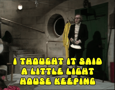 A Man In A Suit Stands In A Room With The Words A Thought It Said A Little Light House Keeping Above Him GIF