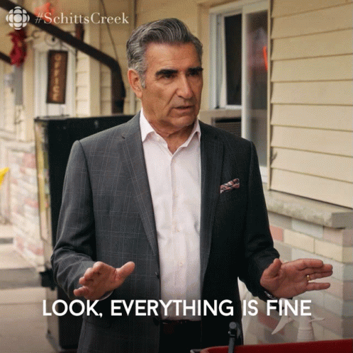 A Man In A Suit Stands In Front Of A Building And Says Look Everything Is Fine GIF