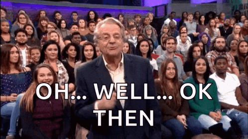 A Man In A Suit Stands In Front Of A Crowd Of People And Says " Oh Well Ok Then " . GIF