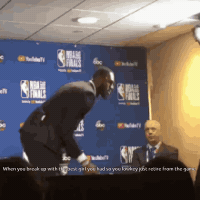 A Man In A Suit Stands In Front Of A Nba Finals Sign GIF