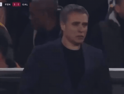 A Man In A Suit Stands In Front Of A Scoreboard That Says Fen 1 Gal On It GIF