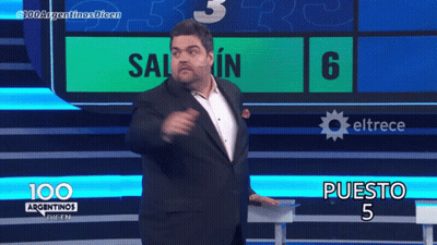 A Man In A Suit Stands In Front Of A Screen That Says 100 Argentinas Dicen GIF