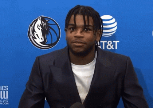 A Man In A Suit Stands In Front Of A Sign That Says At & T GIF