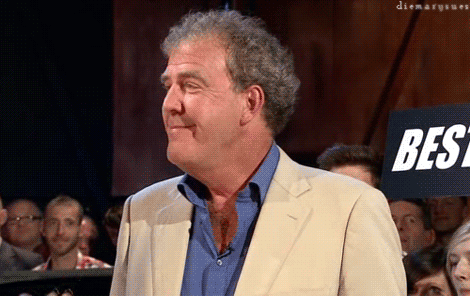 A Man In A Suit Stands In Front Of A Sign That Says Best On It GIF