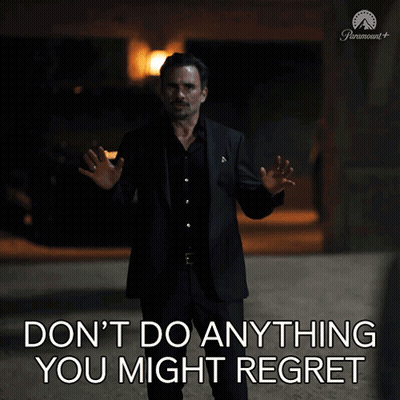 A Man In A Suit Stands In Front Of A Sign That Says " Don 'T Do Anything You Might Regret " GIF