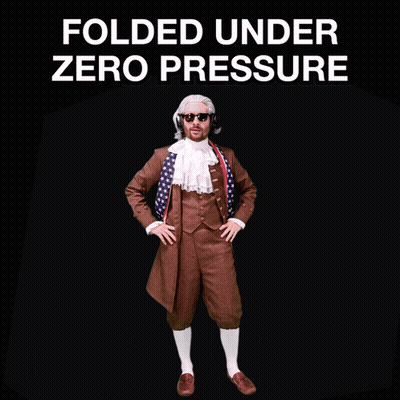 A Man In A Suit Stands In Front Of A Sign That Says " Folded Under Zero Pressure " GIF
