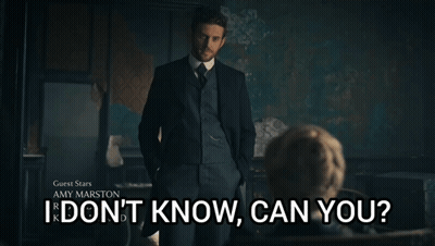 A Man In A Suit Stands In Front Of A Sign That Says Guest Stars Amy Marston I Don 'T Know Can You GIF